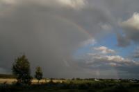 Photo of the rainbow showing itself over the rural fields of Vörå as the dark storm clouds are slowly beginning to disperse after a day of rain and thunder.