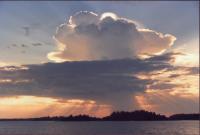 Rays of light is shooting out from behind a large mushroom shaped cloud over the bay of Storviken.